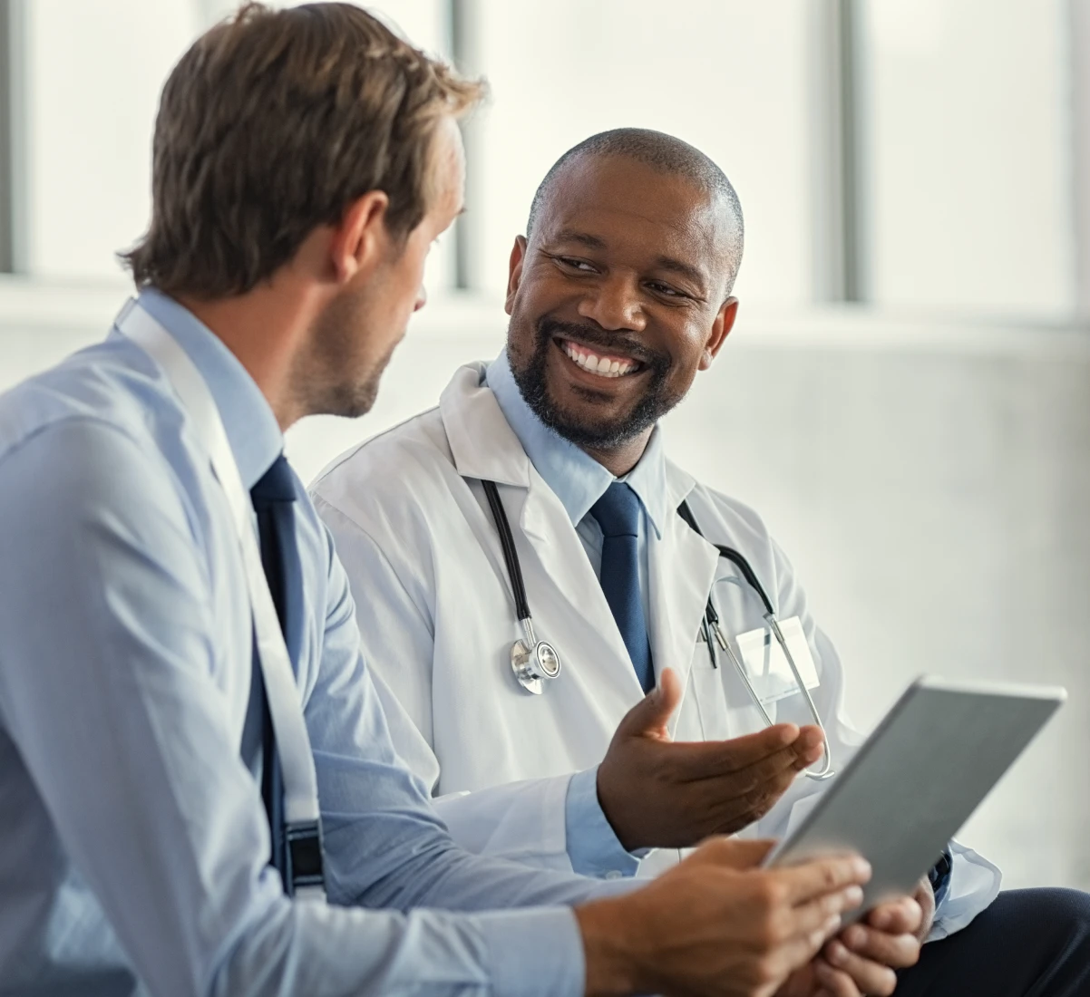 Smiling doctor talking to professional man